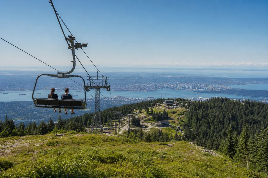 Chairlift climbing toward a mountain peak